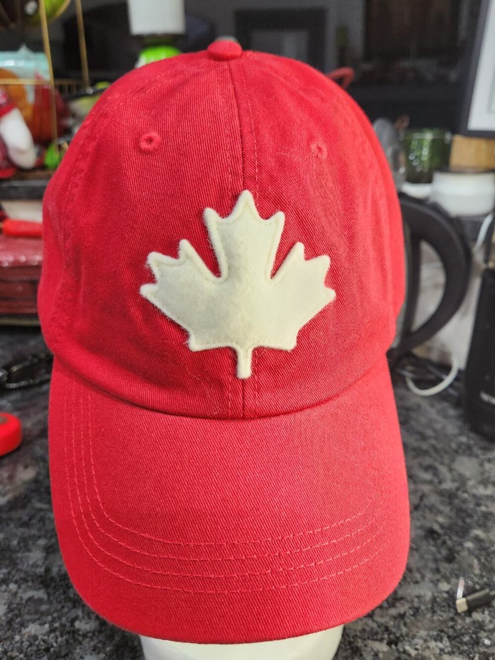 Roots had red baseball cap features a prominent embroidered logo